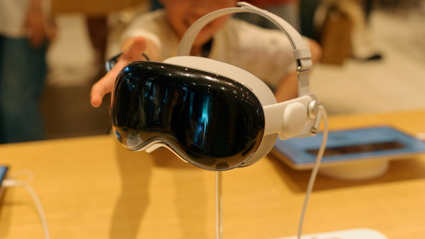 A baby wearing a pair of headphones on top of a table