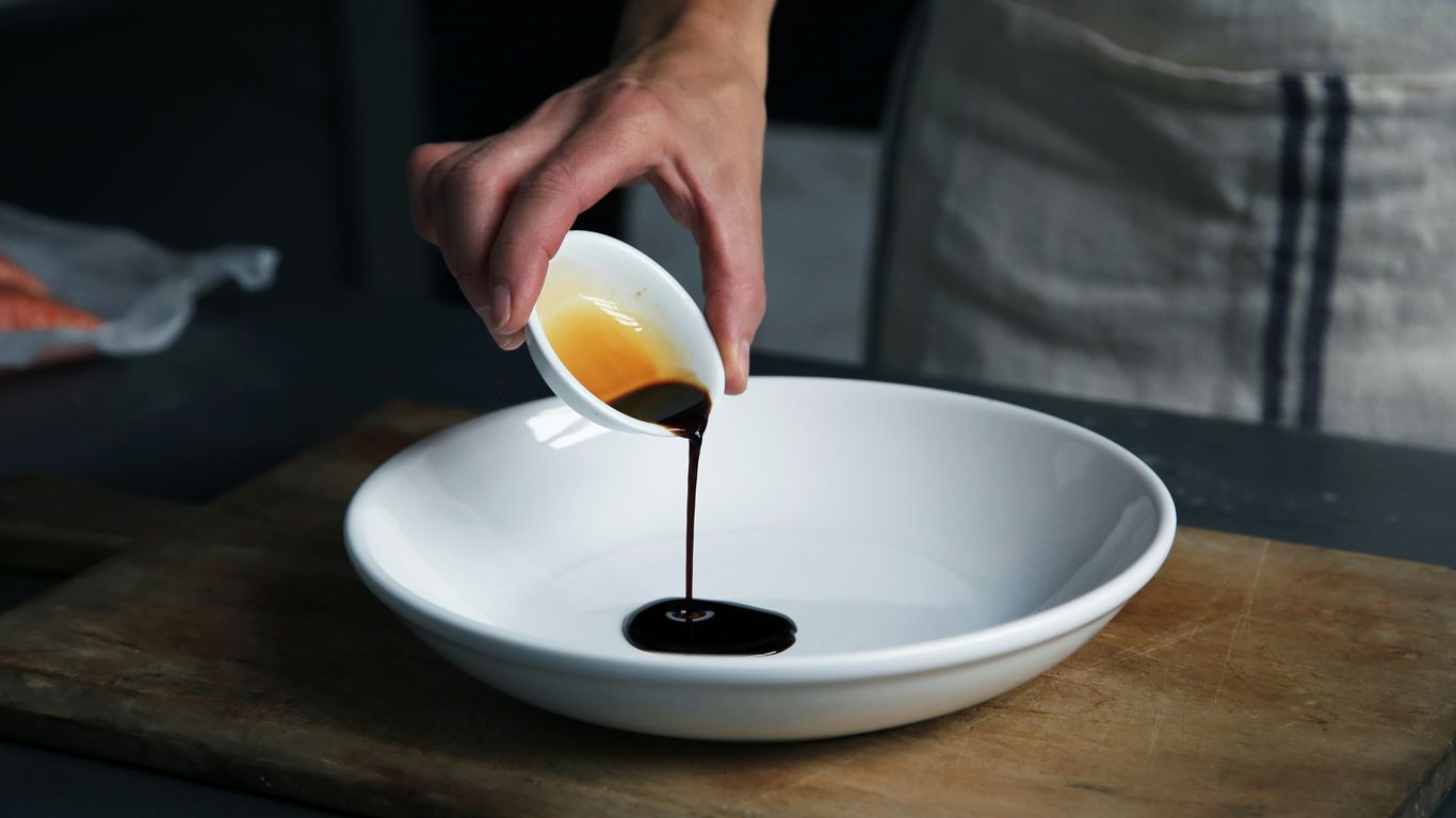 Small bowls of dark soy sauce and chilli