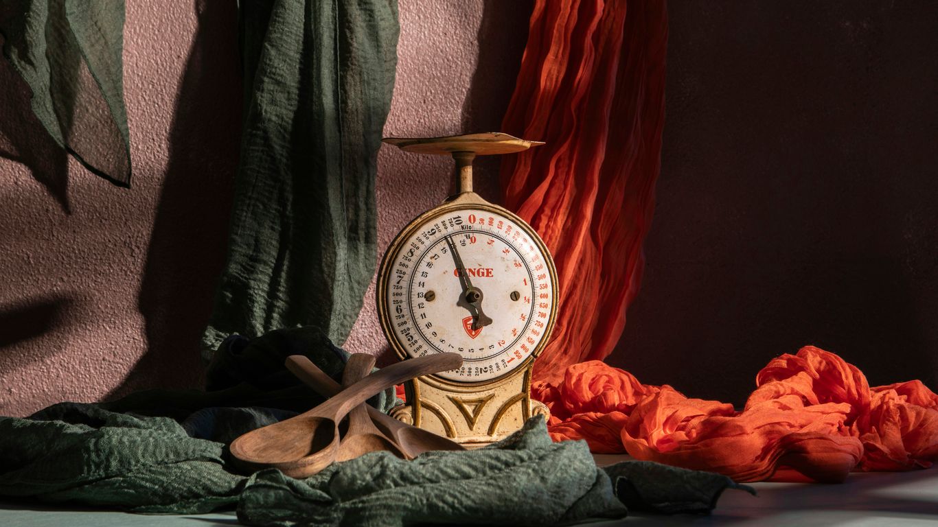 A vintage scale is posed with colorful fabrics.