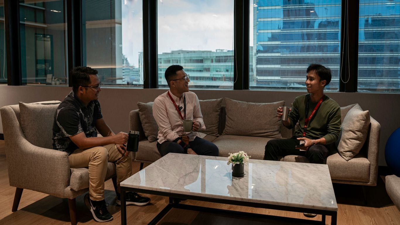 Three men sitting on couches in a living room