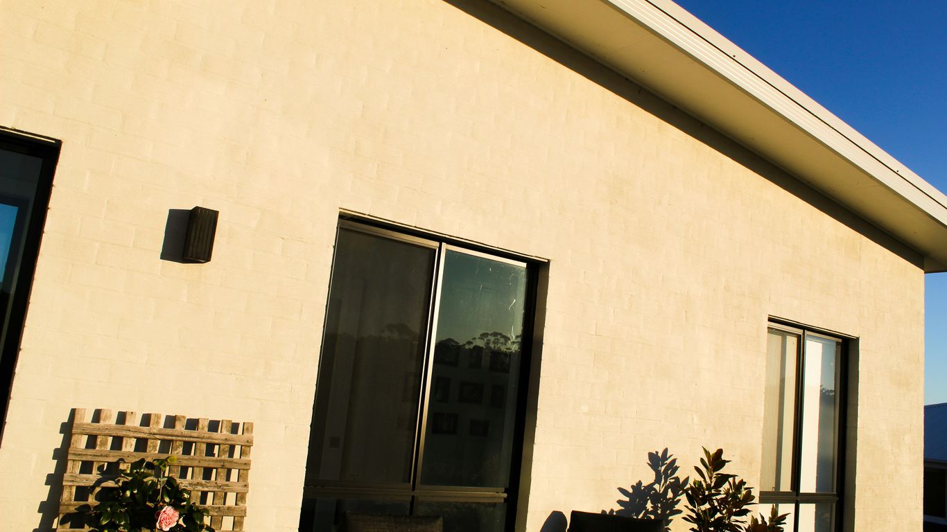 A white house with a black door and windows