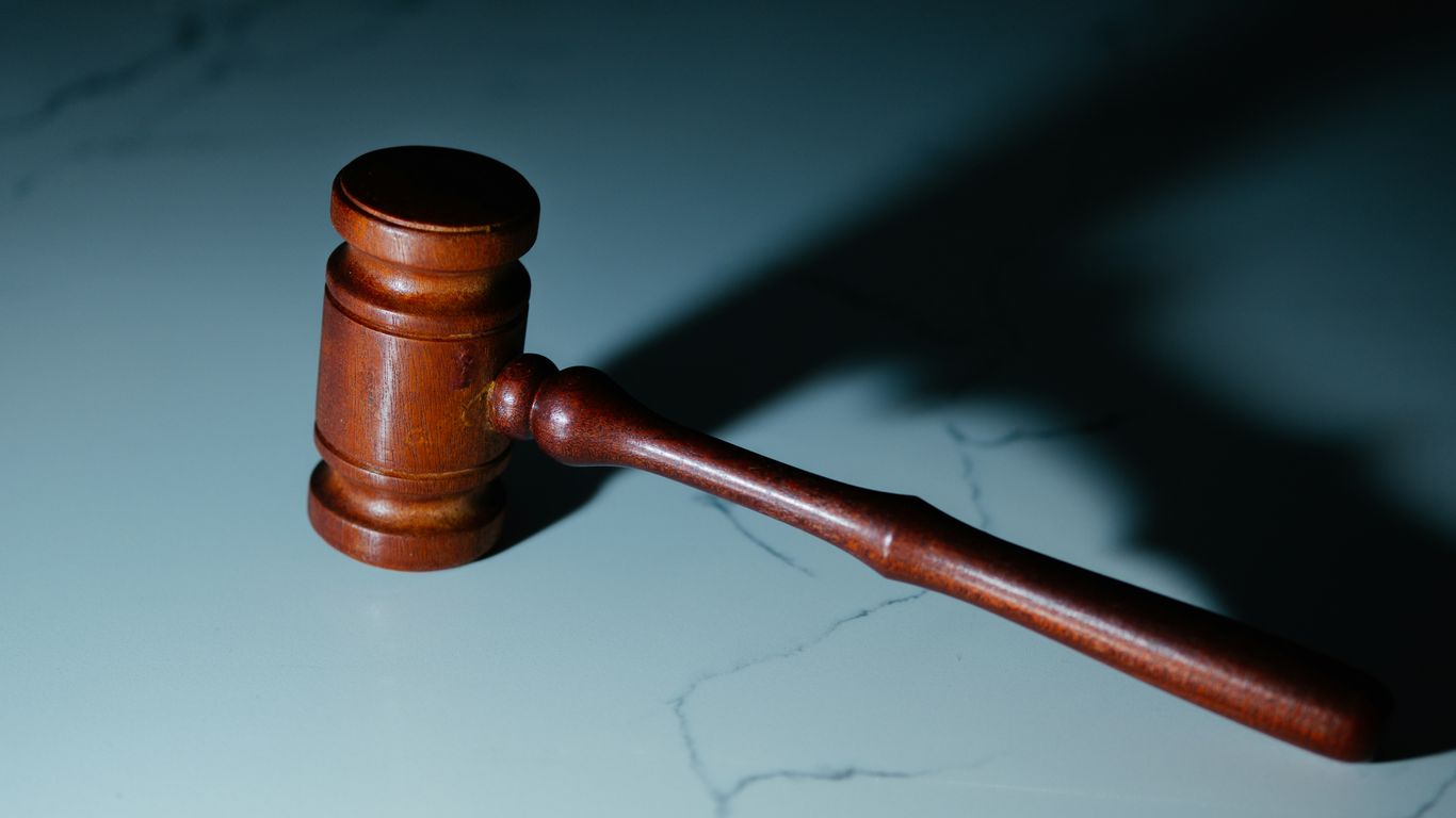 a wooden judge's hammer sitting on top of a table