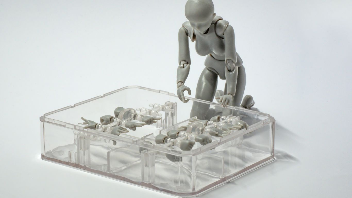 a small plastic man standing on a table