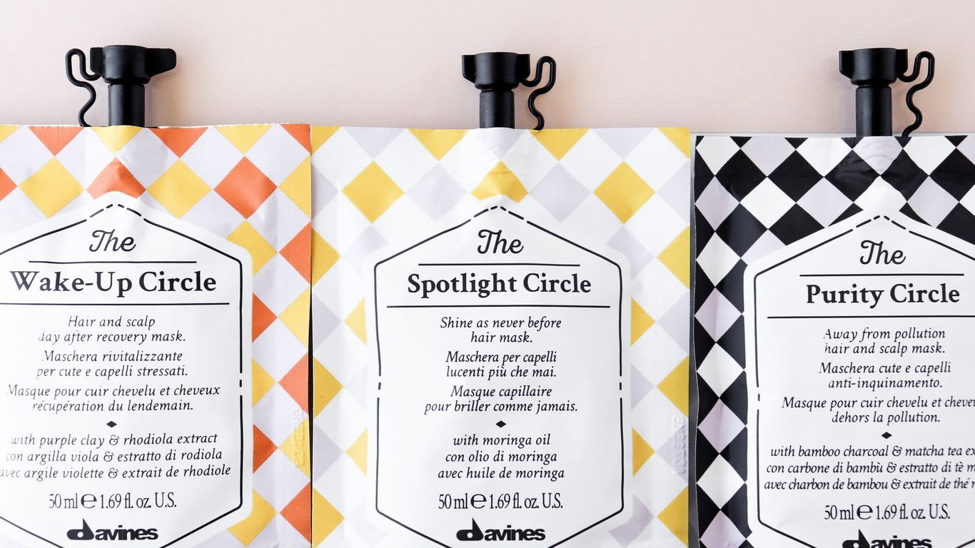 Three hair product sachets with geometric patterns and text descriptions.