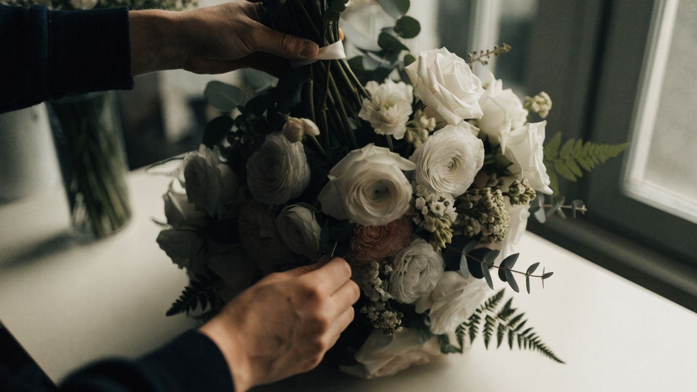 Florist preparing a gentle funeral flower arrangement