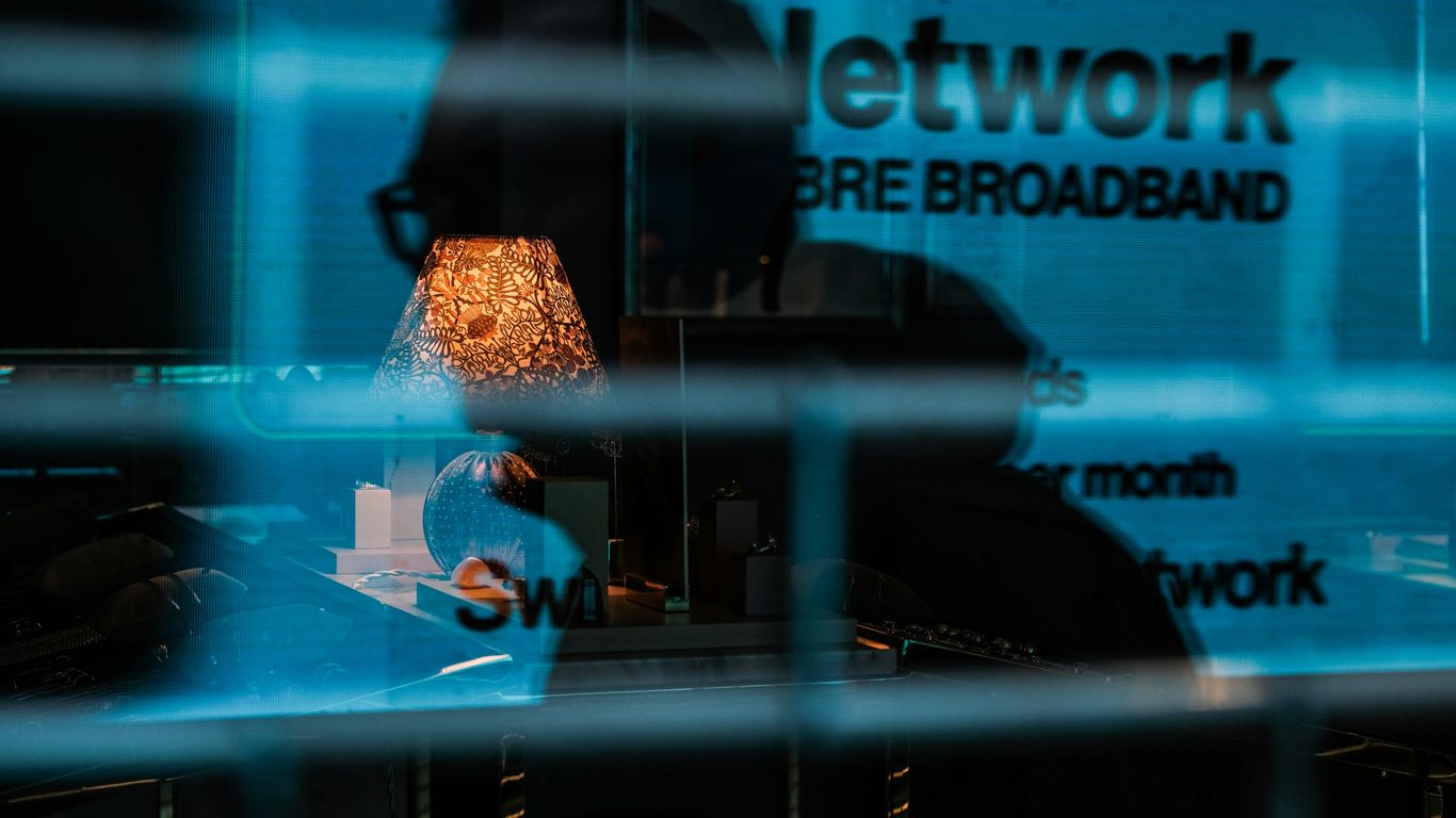 a reflection of a lamp in a glass window