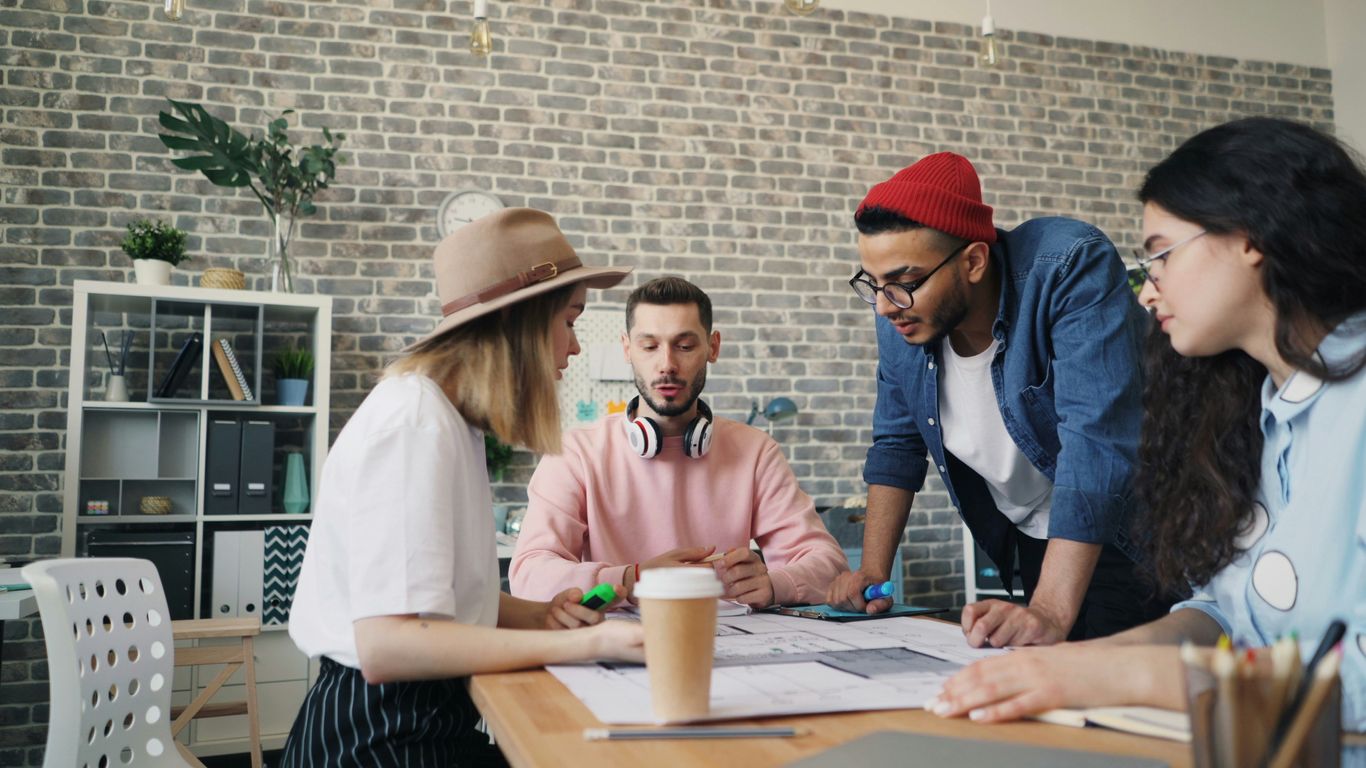a group of people standing around a table