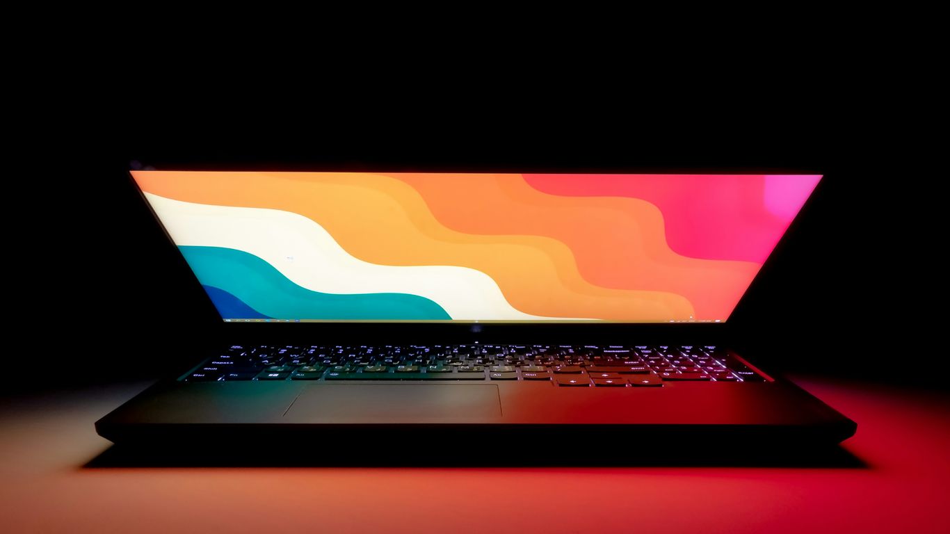 macbook pro on black table