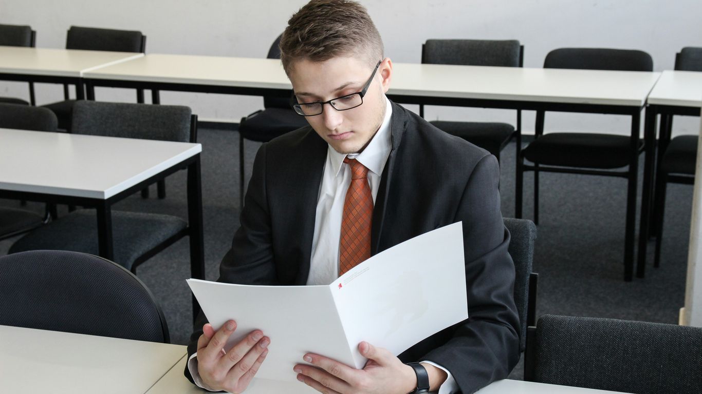 man holding folder in empty room