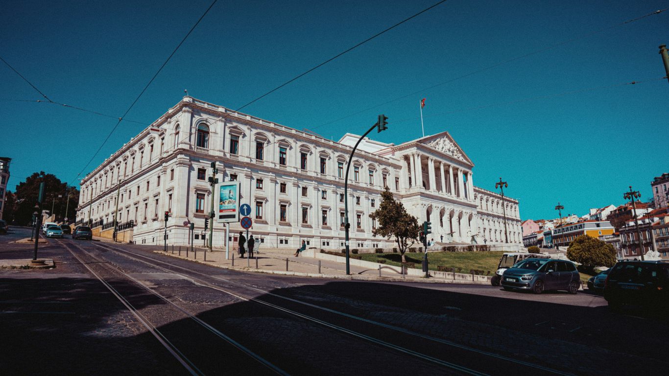 a large white building sitting on the side of a road