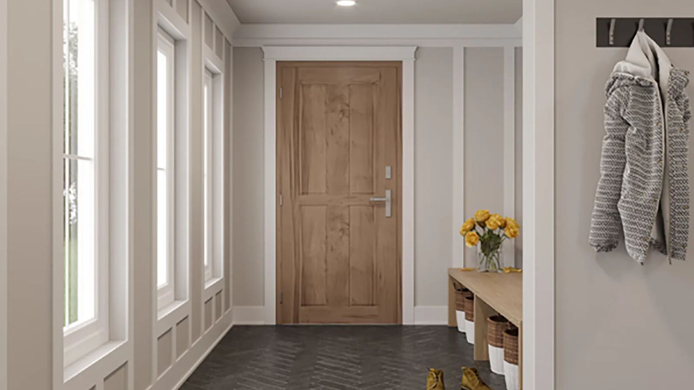 A clean entryway with a wooden door, bench, and coat rack.