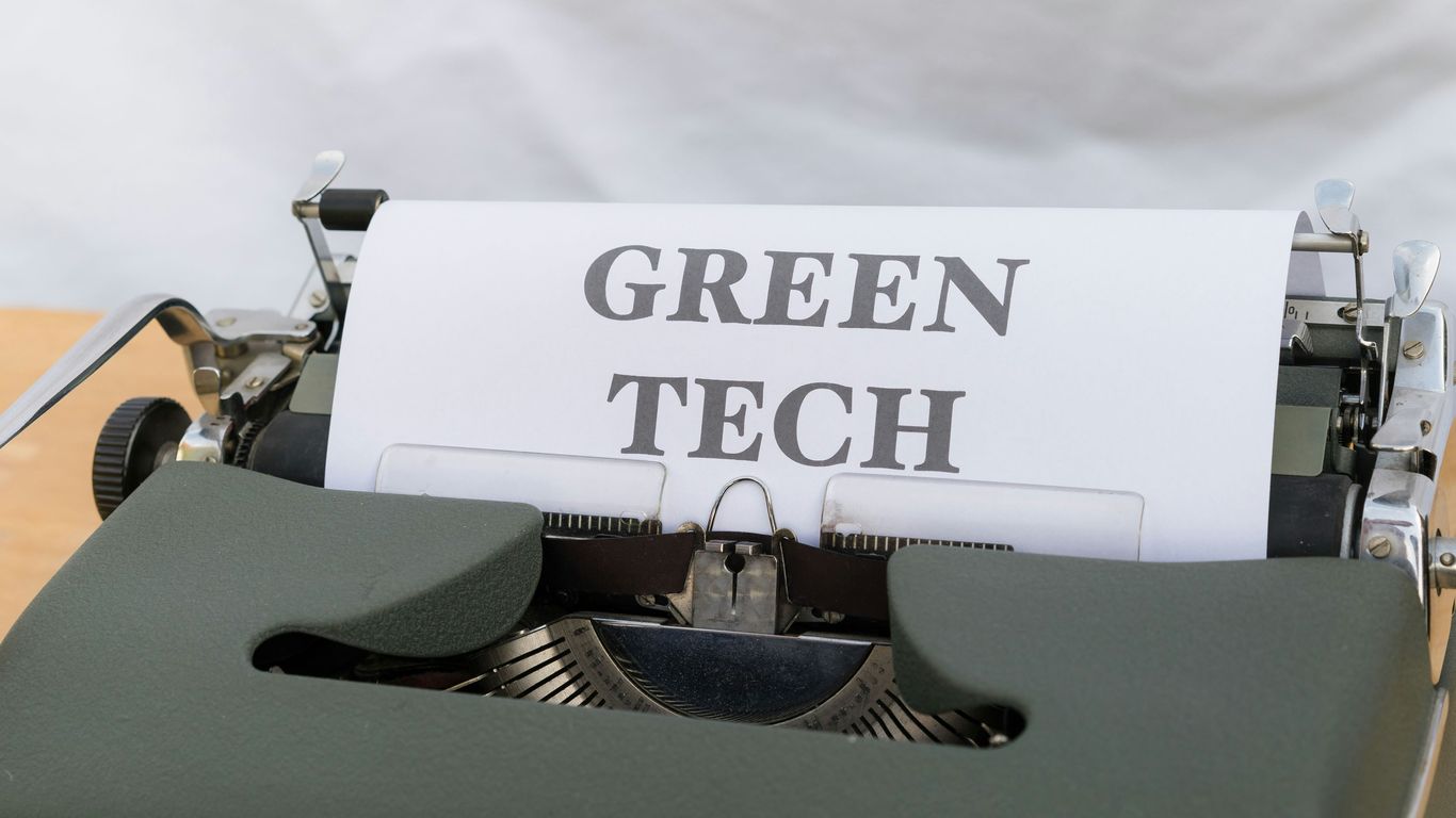 an old typewriter with a green tech sign on it
