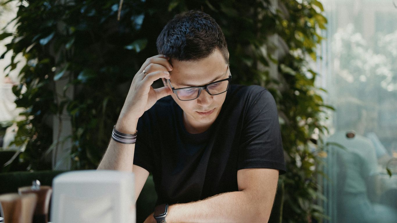 man in black crew neck t-shirt wearing black framed eyeglasses