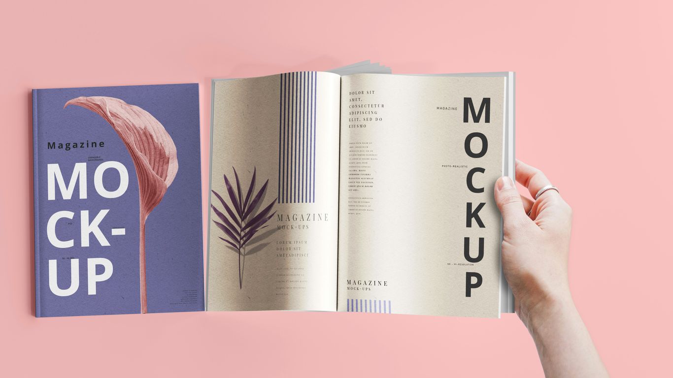 a hand holding a book open to a mockup