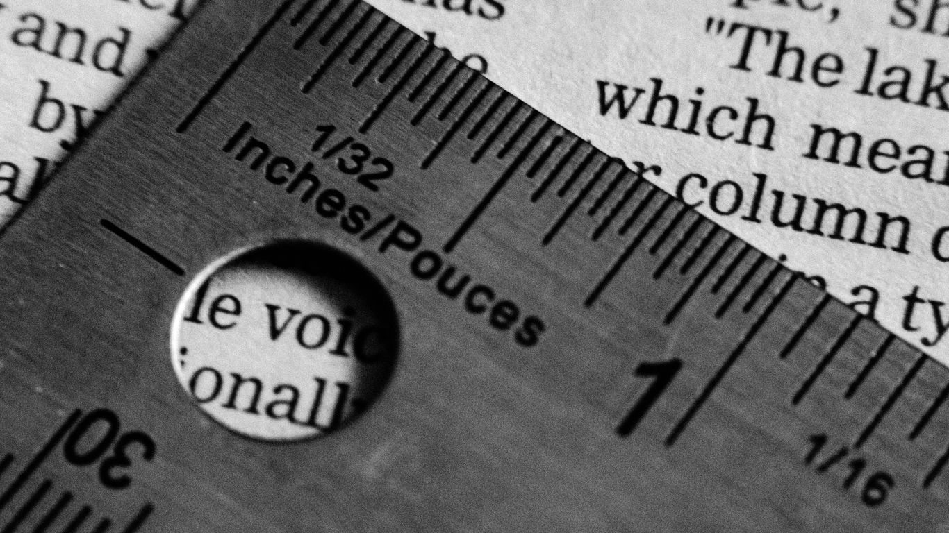 A ruler measuring text on a page.