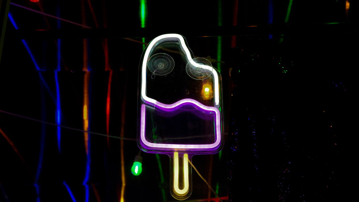 a neon sign with a purple ice cream on it