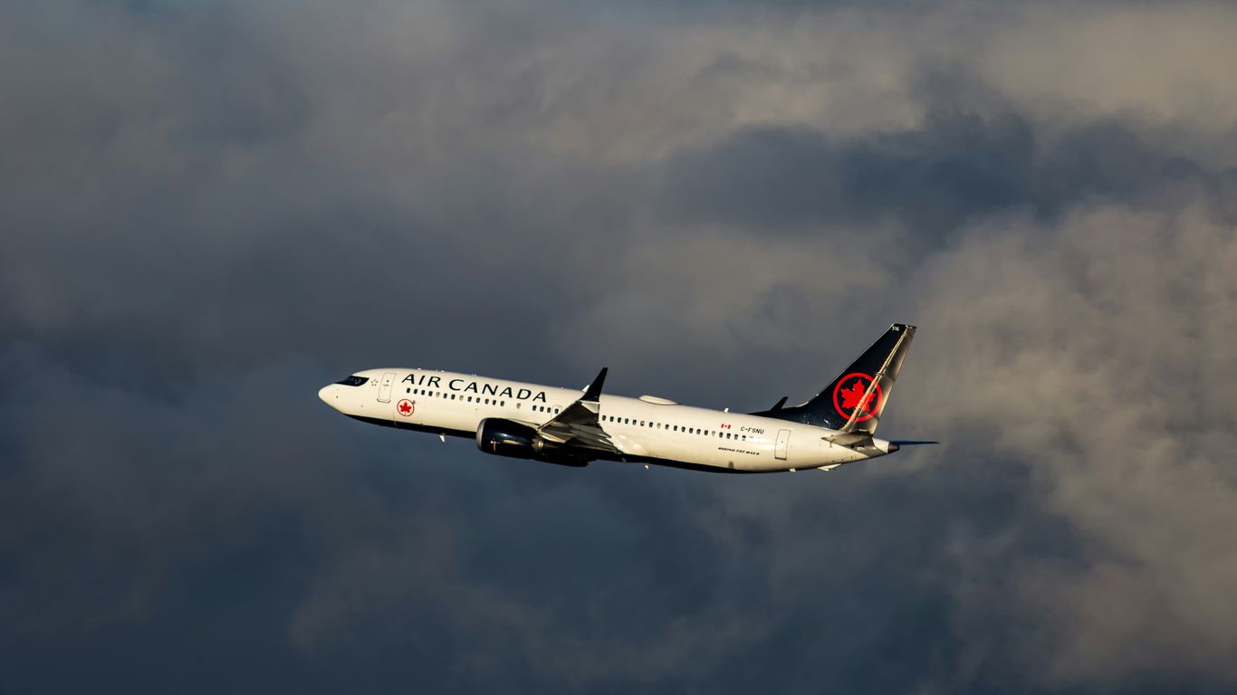 Air canada airplane ascending through clouds