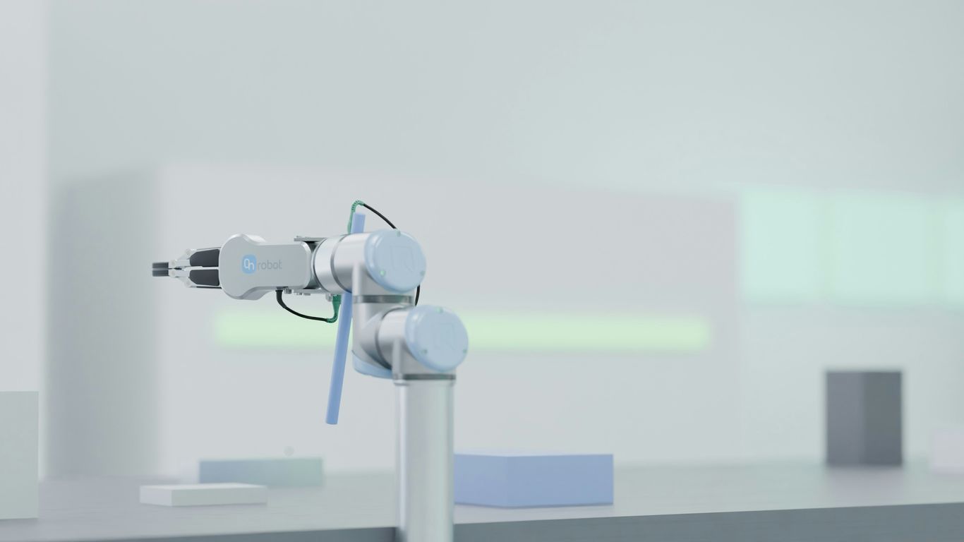 Machine tending cobot beside industrial equipment