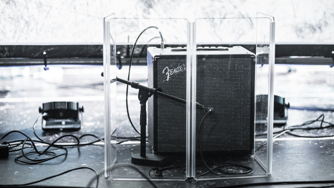 black Fender guitar amplifier in clear acrylic organizer