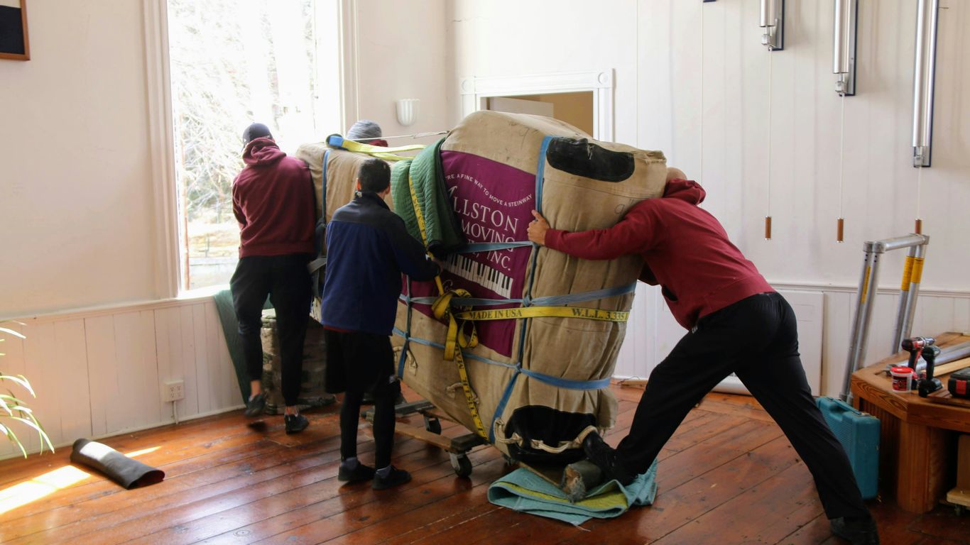 Delivery team coordinating marble furniture access