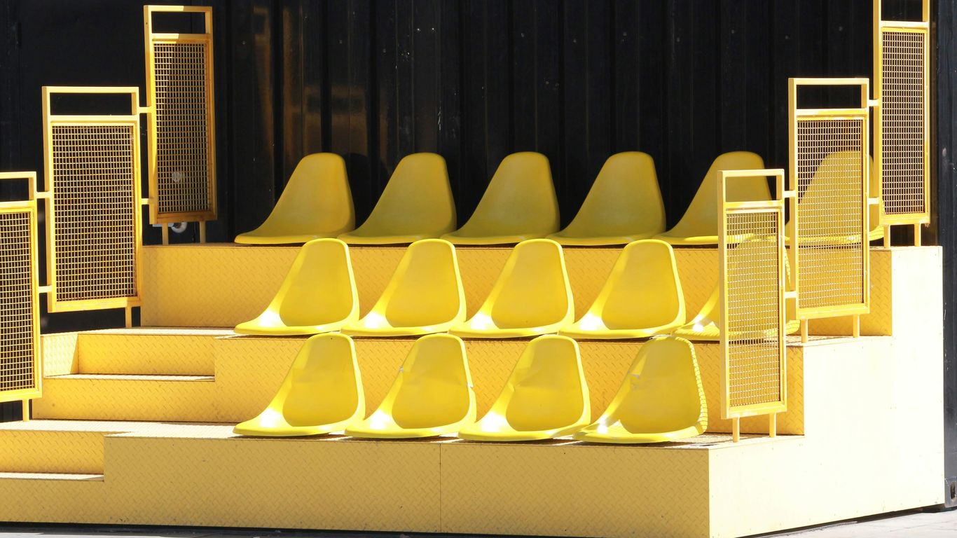 yellow plastic chairs on white wooden table