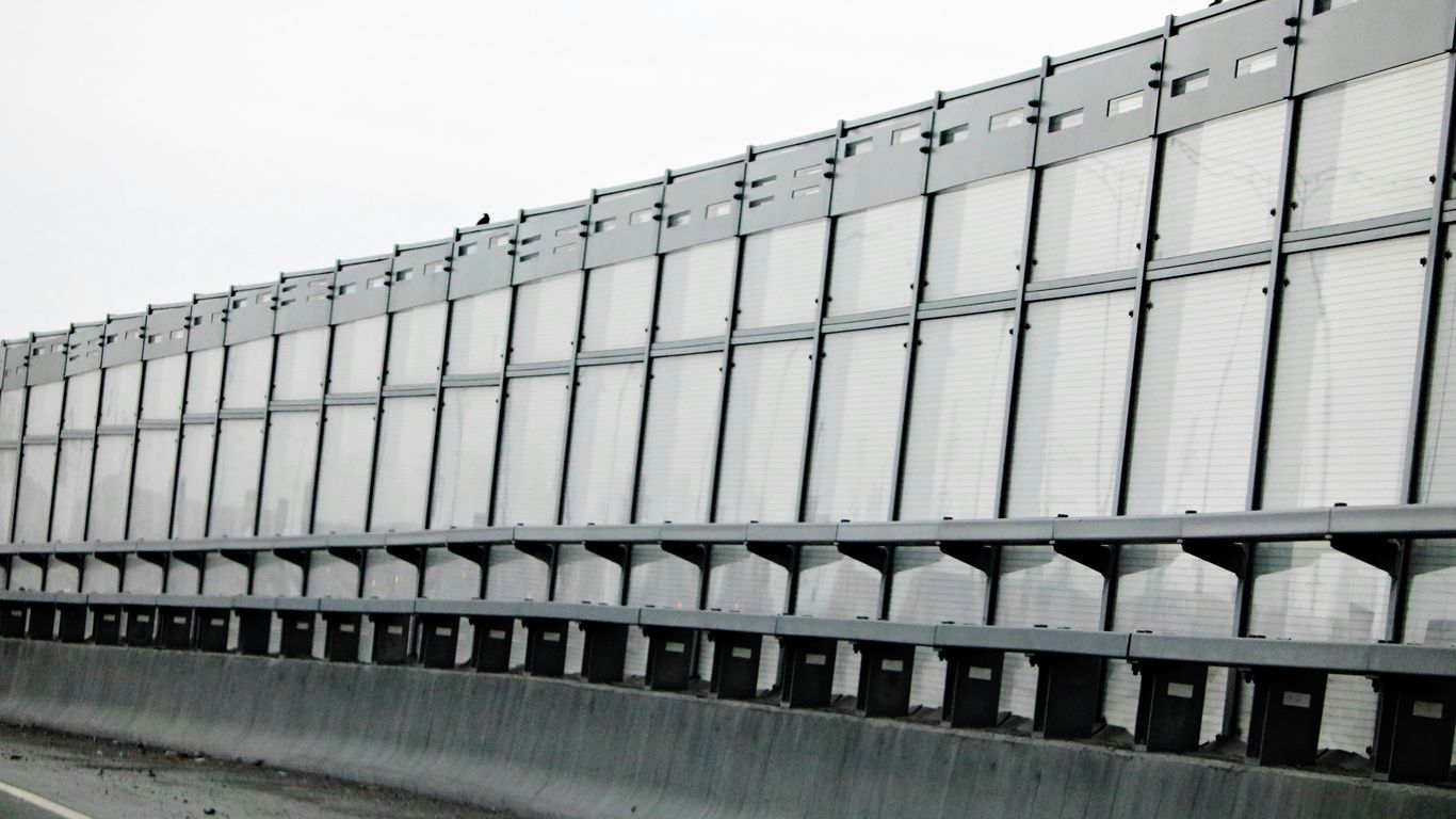 a large metal structure sitting on the side of a road