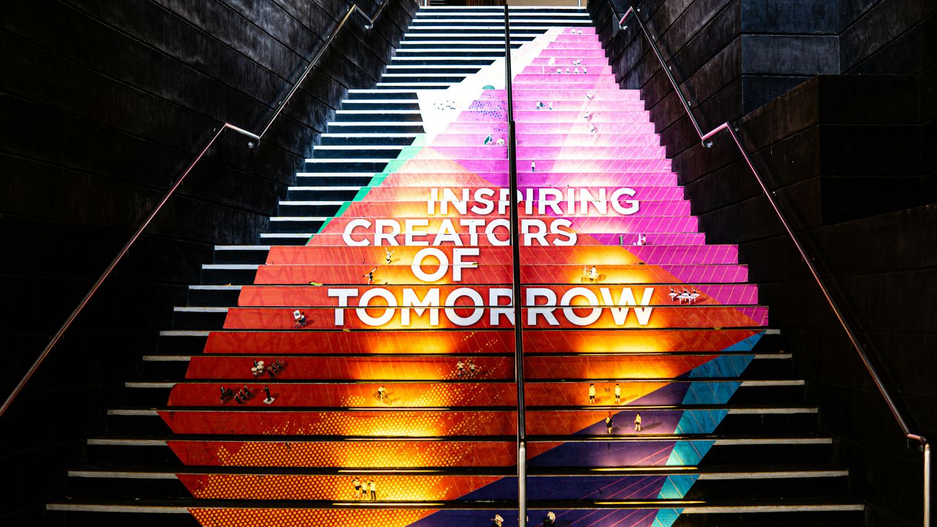 A stair case with a painting on the side of it
