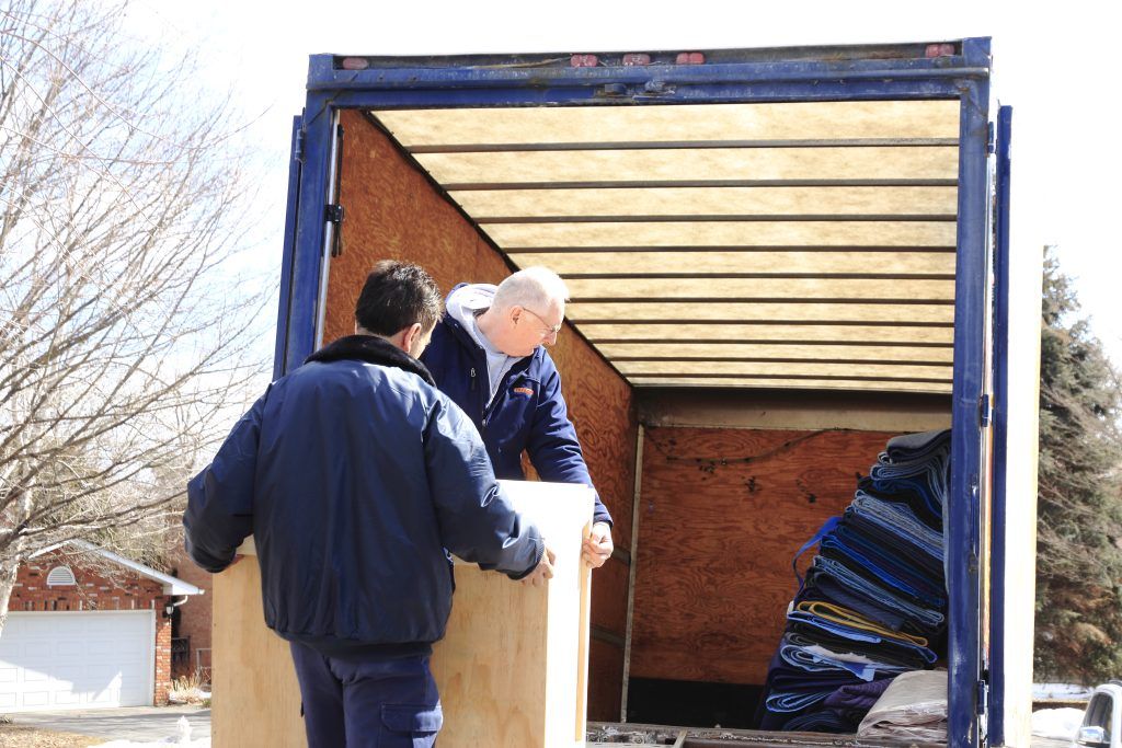 A truck moving items to a new home