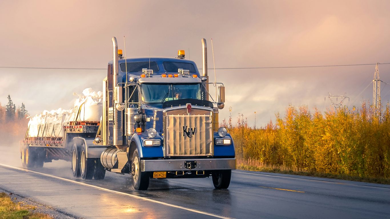 white and blue truck on road during daytime