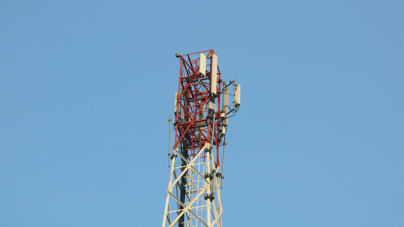 a cell phone tower with a blue sky in the background
