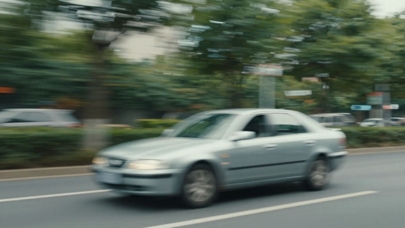 Car speeding down a road, motion blur.