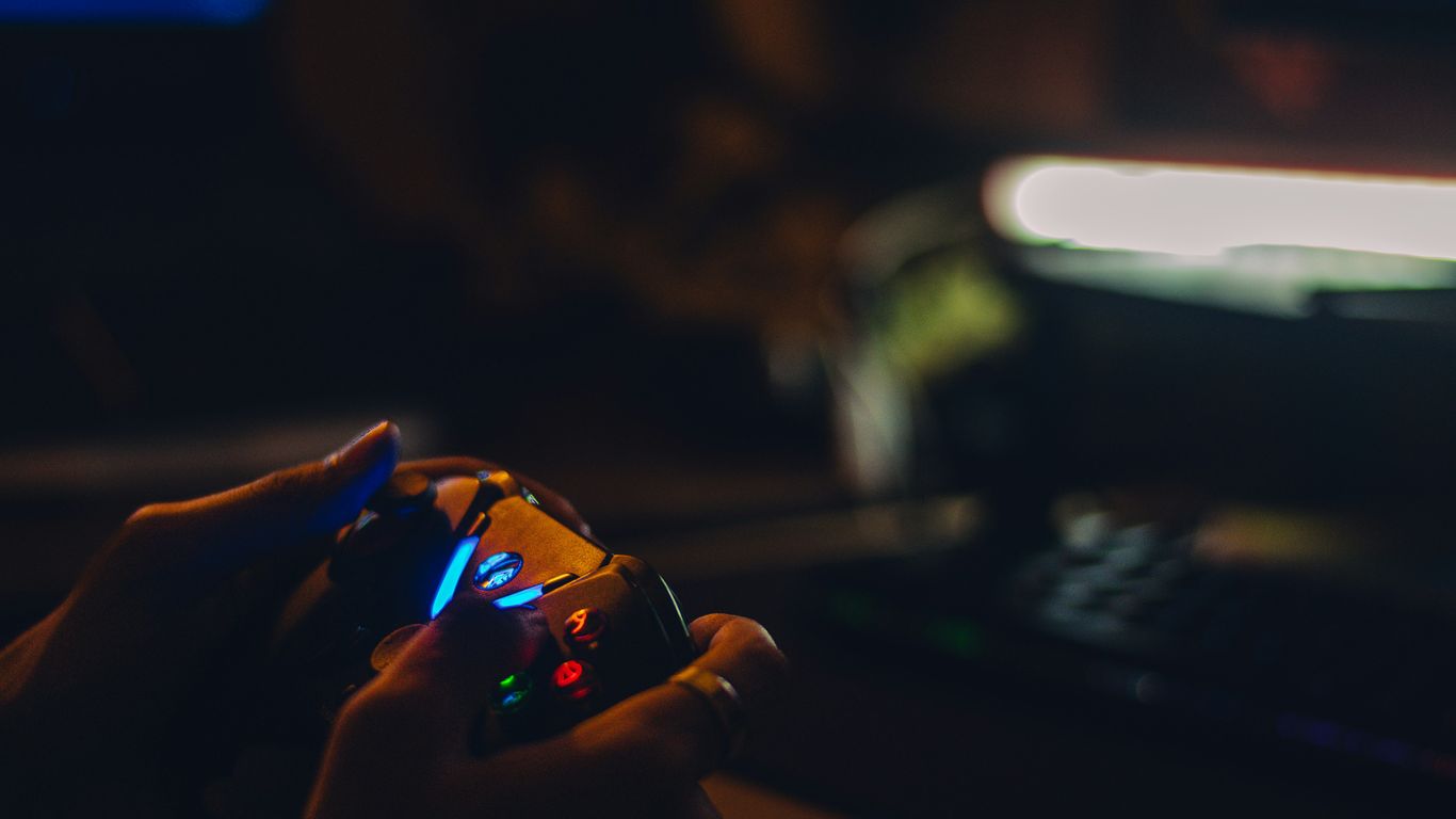 a person holding a game controller in their hand