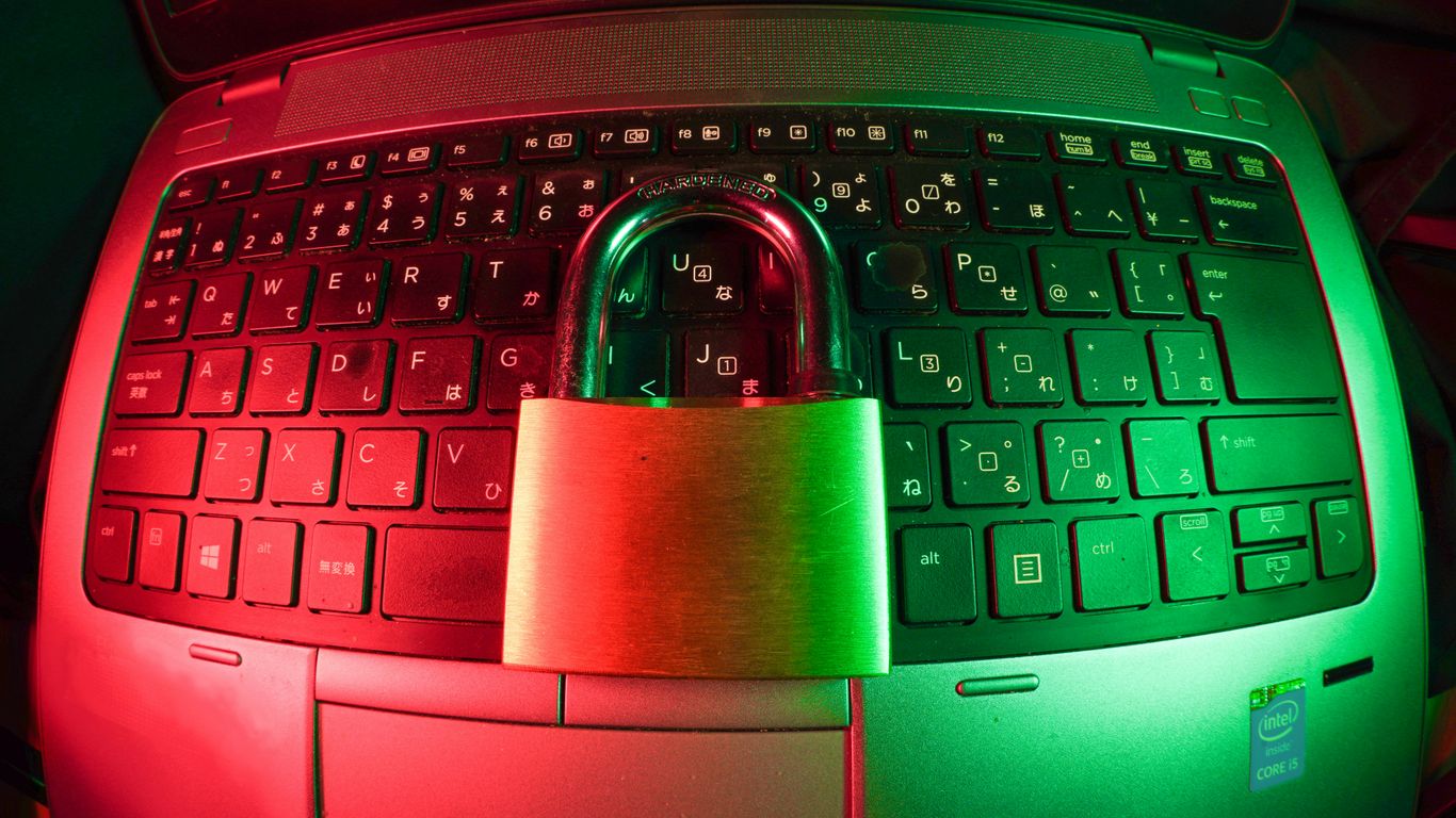 pink and silver padlock on black computer keyboard