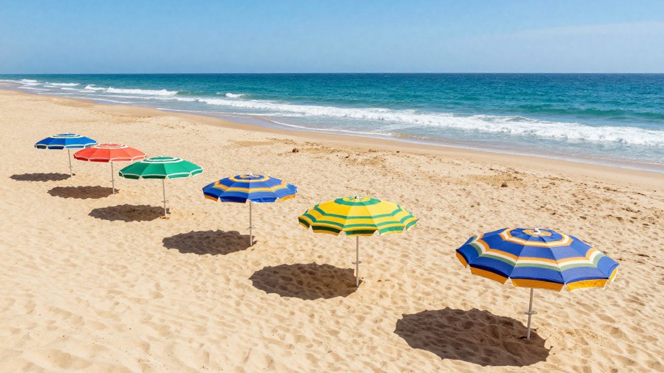 A beach scene showing sun umbrellas on sand