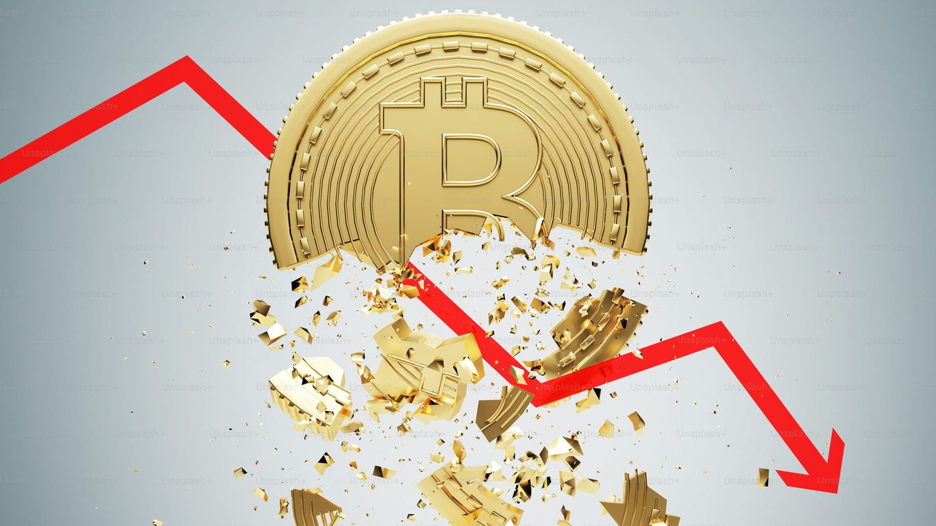 Bitcoin coin breaking apart with a downward red trend line.