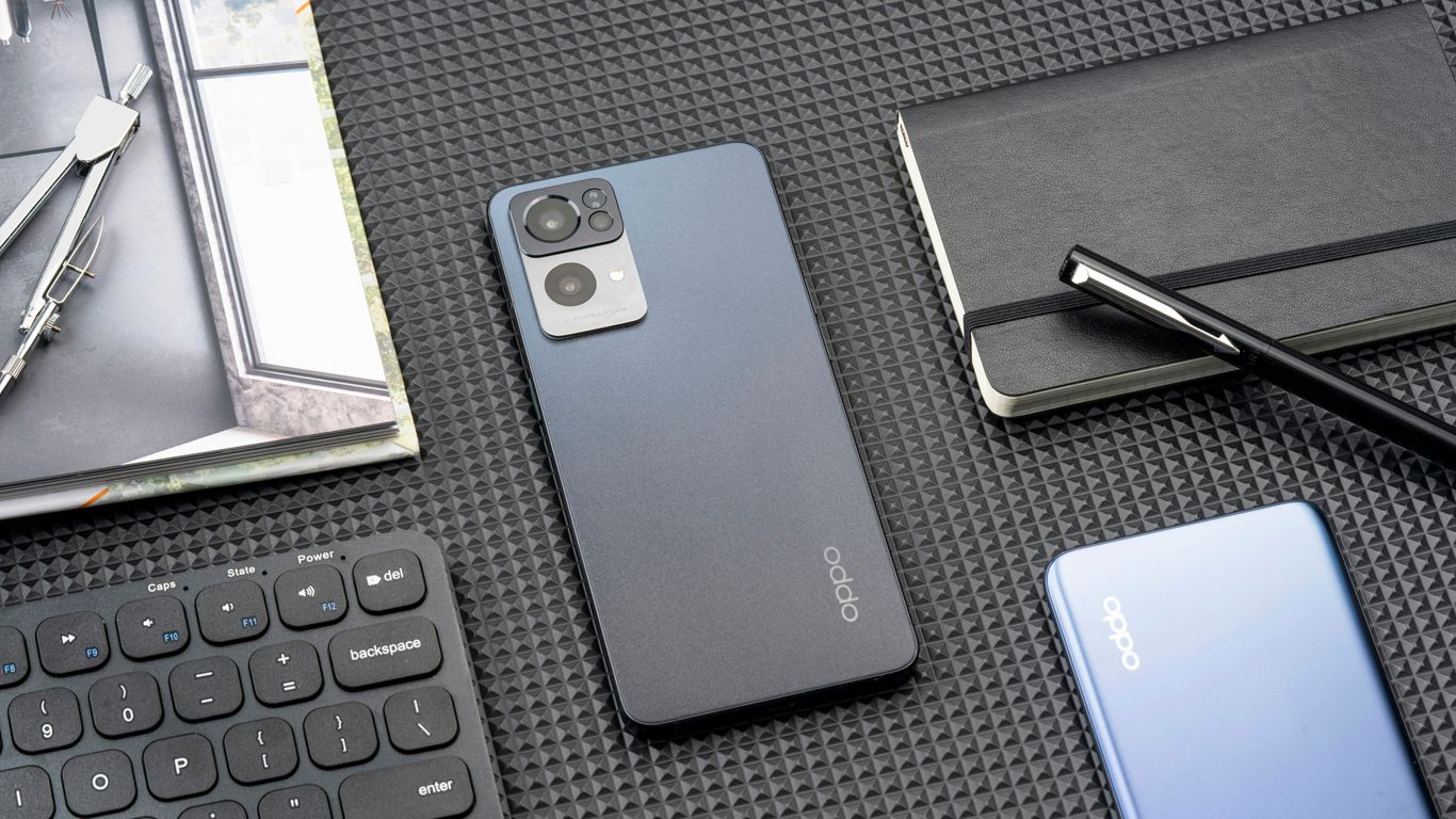 a cell phone sitting on top of a table next to a keyboard