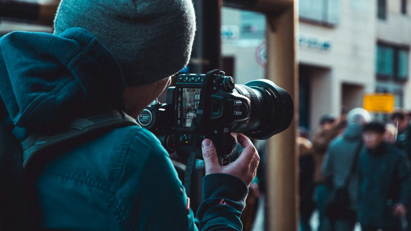 Professional videographer filming a live conference event