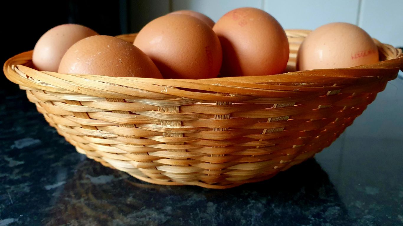 a basket of eggs sitting on a counter top
