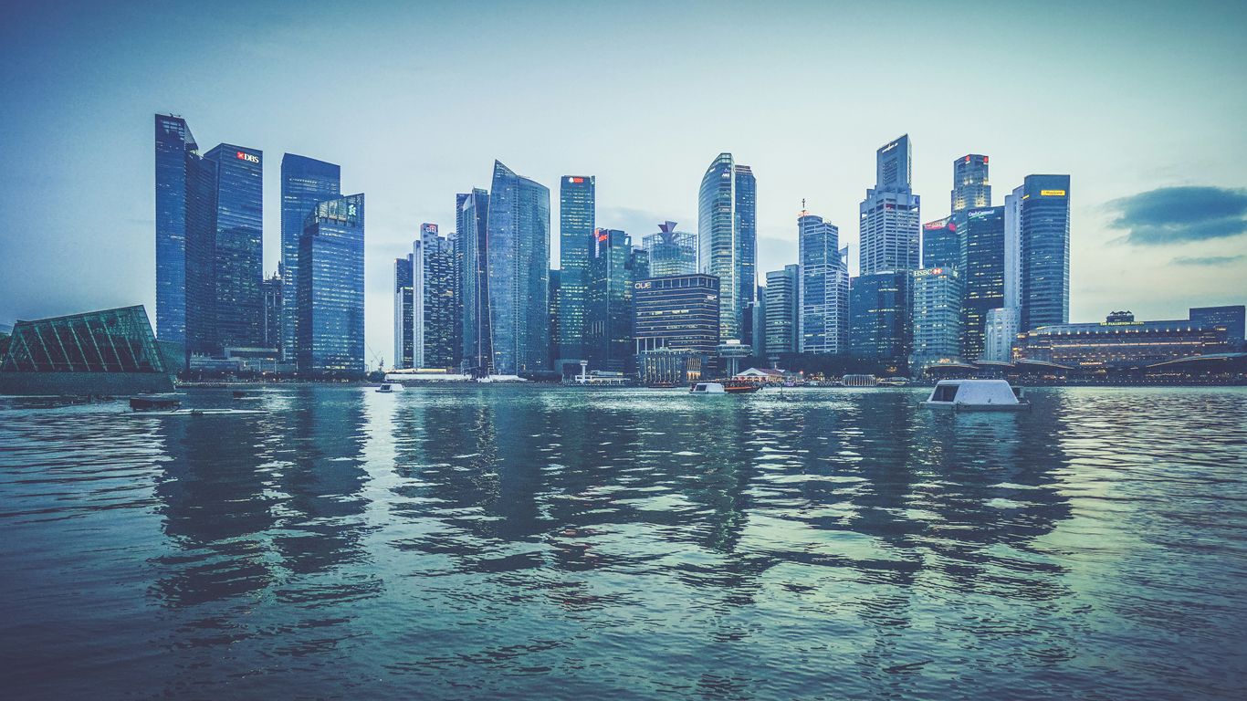 gray buildings near body of water at daytime