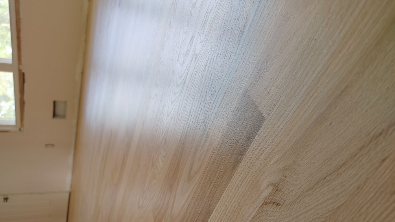 Smooth wooden floor in a room with natural light.