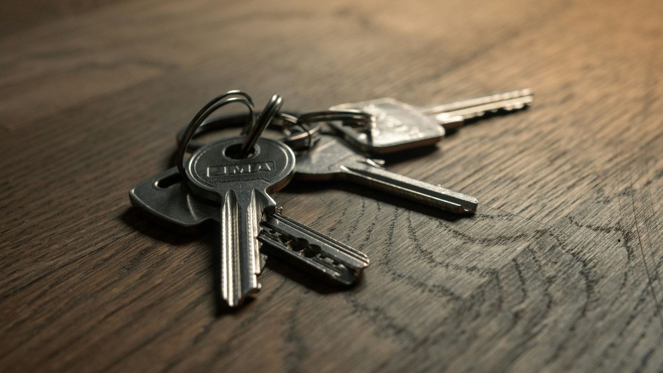 Technician holding keys beside a vehicle