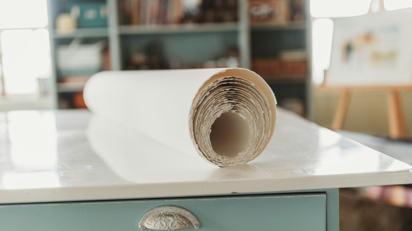 gold round coin on white paper