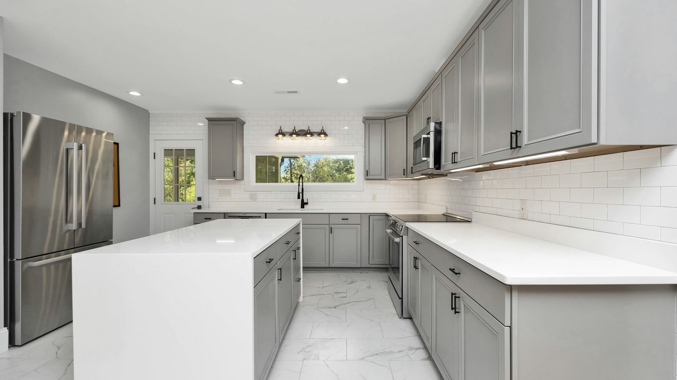 a kitchen with white cabinets