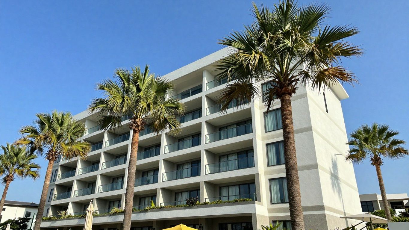 Oaks Darwin Elan Hotel exterior with palm trees.