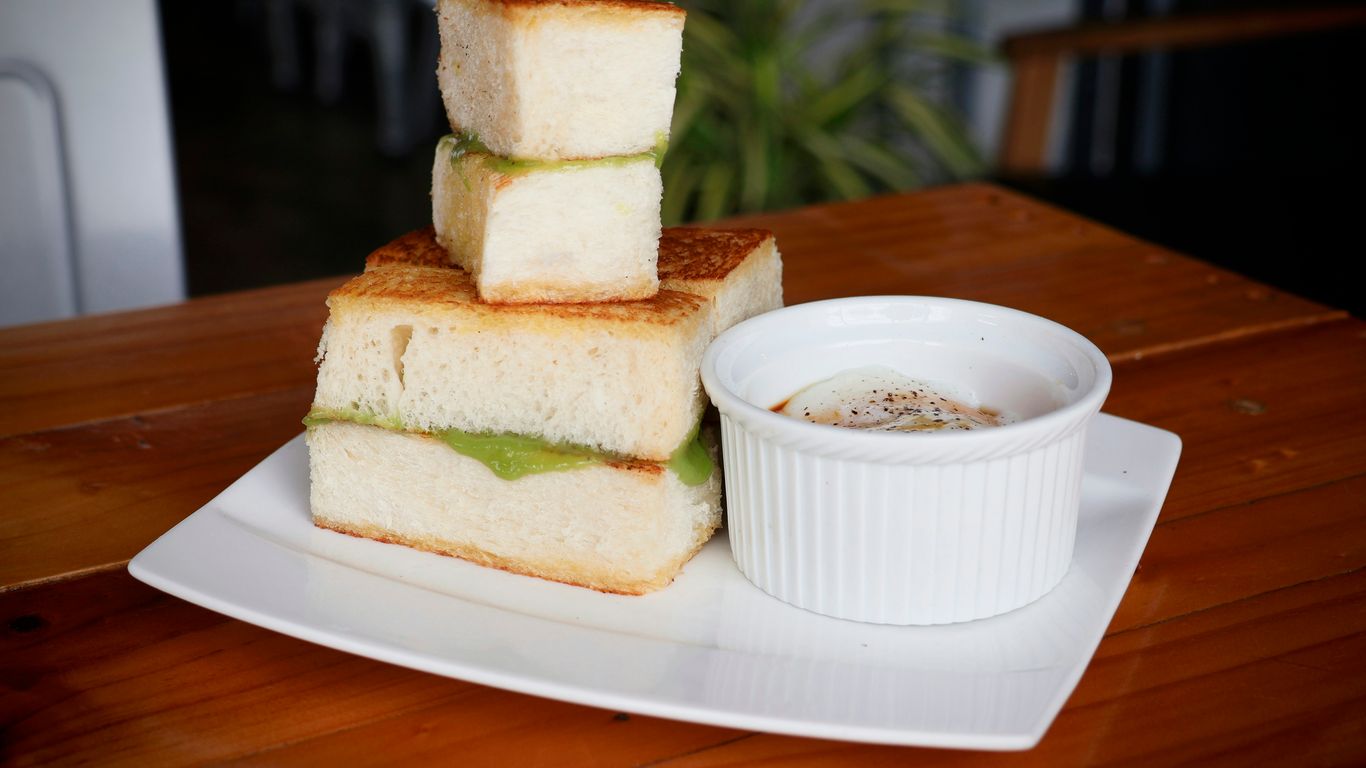 a sandwich and a cup of coffee on a plate