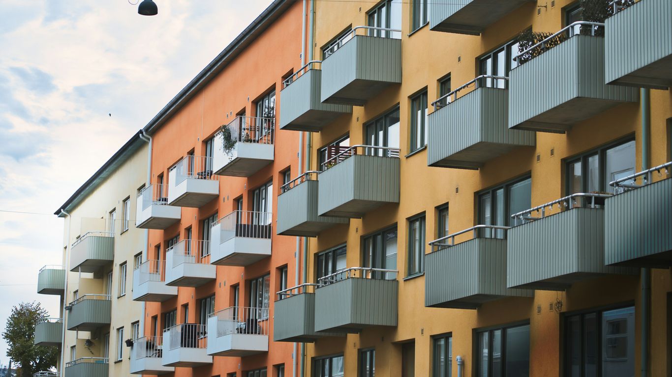 High-rise public housing blocks beneath tropical clouds