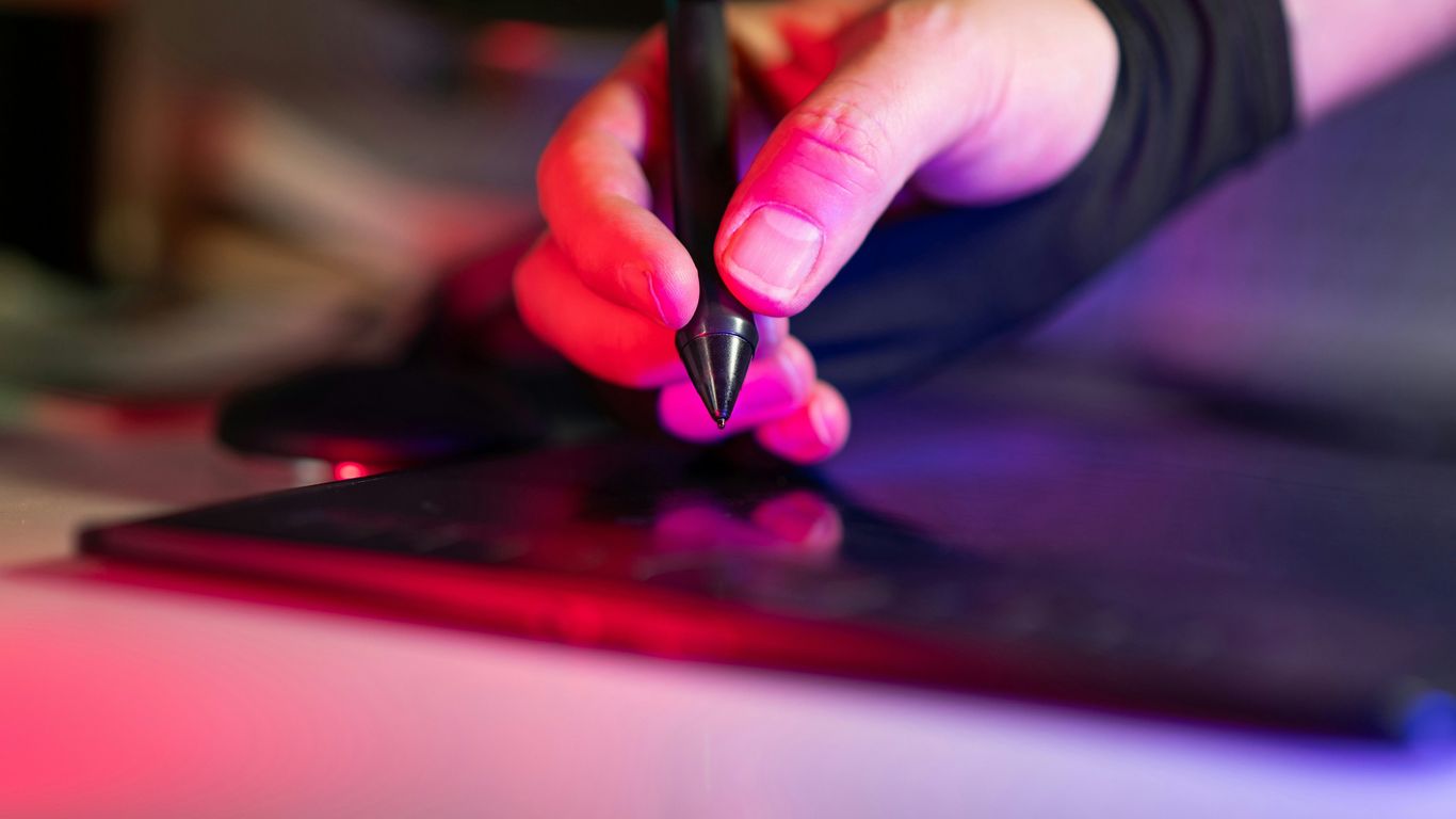 A designer working on vector graphics for acrylic production