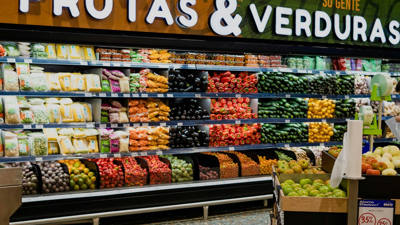 a produce section of a grocery store filled with fruits and veggies
