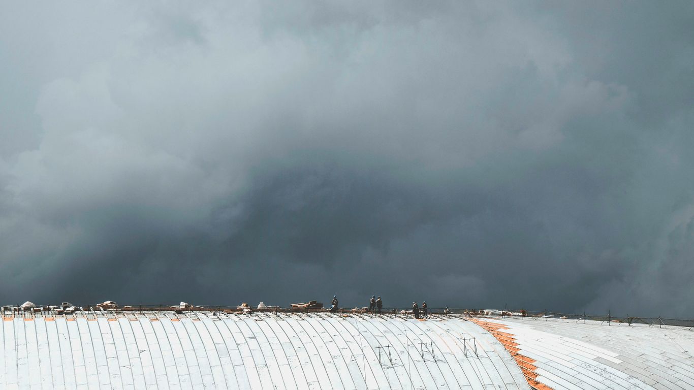 people standing on gray roof