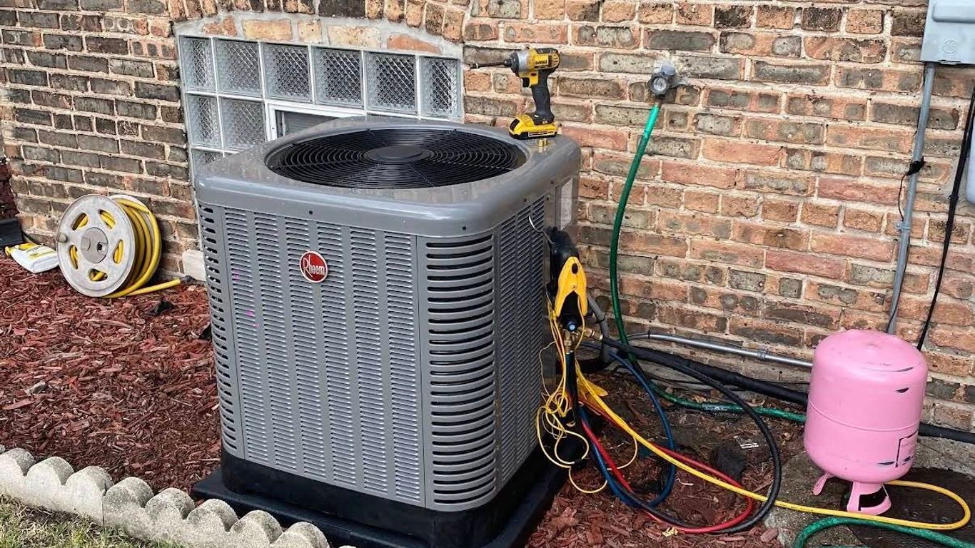 Air conditioning unit with tools and hoses connected to it.